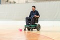 Disabled man on an electric wheelchair playing sports, powerchair hockey. IWAS - International wheelchair and amputee