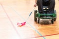 Disabled man on an electric wheelchair playing sports, powerchair hockey. IWAS - International wheelchair and amputee