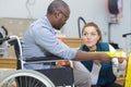 disabled man in hardware store with woman seller Royalty Free Stock Photo