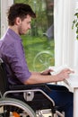 Disabled man at home reading a book Royalty Free Stock Photo