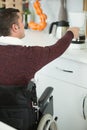 disabled man in kitchen making coffee Royalty Free Stock Photo