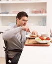 Disabled Man Making Sandwich In Kitchen Royalty Free Stock Photo