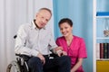 Disabled man and nurse in a hospice