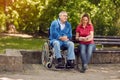 Disabled man in park spending time together with his daughter re Royalty Free Stock Photo