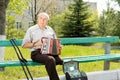 Disabled man playing the accordion Royalty Free Stock Photo