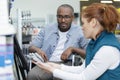 disabled man shopping in hardware store helped by seller Royalty Free Stock Photo