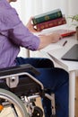 A disabled man sitting and learns Royalty Free Stock Photo