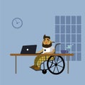 A disabled man sitting in a wheelchair at the desk with laptop