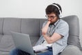 Disabled man student with amputated two stump hands studying on laptop at home. Royalty Free Stock Photo