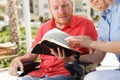 Disabled man studying Holy Bible. Royalty Free Stock Photo