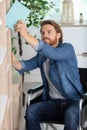 disabled man taking book from shelf Royalty Free Stock Photo