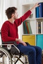 Disabled man taking book Royalty Free Stock Photo