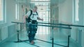 Disabled man is walking in the exosuit by himself