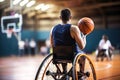 Disabled man in a wheelchair with a basketball. Basketball court. Sports for people with disabilities. Active life Royalty Free Stock Photo