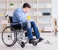 Disabled man on wheelchair cleaning home