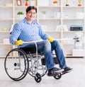 Disabled man on wheelchair cleaning home