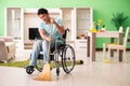 The disabled man on wheelchair cleaning house