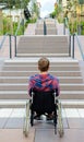 Disabled man in wheelchair in front of stairs Royalty Free Stock Photo