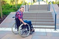 Disabled man in wheelchair in front of stairs Royalty Free Stock Photo