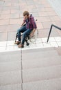 Disabled man in wheelchair in front of stairs Royalty Free Stock Photo