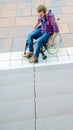 Disabled man in wheelchair in front of stairs Royalty Free Stock Photo