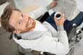 disabled man in wheelchair holding coffee and newspaper