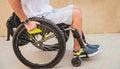 Disabled man in a wheelchair moves on a ramp to the beach. Royalty Free Stock Photo