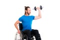 Disabled man in wheelchair train with bar-bell