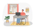 Disabled man in wheelchair working at computer in home. Freelance worker sitting at desk in front of desktop computer Royalty Free Stock Photo