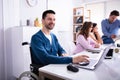 Disabled Man On Wheelchair Working In Office Royalty Free Stock Photo