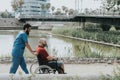 disabled man who goes in a wheelchair is transported by a doctor