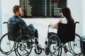 Disabled Man and Woman near Black Airport Placards