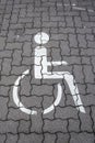 Disabled parking permit sign painted on gray concrete stone on t