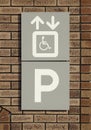 Disabled parking sign on brick wall Royalty Free Stock Photo