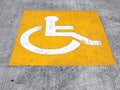 handicapped sign on parking lot floor, universal symbol for representing equal accessibility and inclusion for disabled