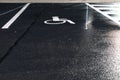 Disabled parking sign painted on dark asphalt at night Royalty Free Stock Photo