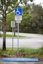 Disabled parking space, wheelchair sign, symbols and fine notice on the parking place in the park Royalty Free Stock Photo
