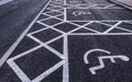 Disabled parking spaces painted on a tarmac road Royalty Free Stock Photo