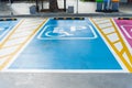 Disabled parking symbol painted in bright blue on parking space. Royalty Free Stock Photo
