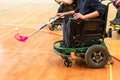 Disabled People on an electric wheelchair playing sports, powerchair hockey. IWAS - International wheelchair and amputee