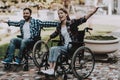 Disabled People on Wheelchairs Have Fun in Park. Royalty Free Stock Photo