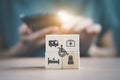 Disabled person, ambulance, medical bag, bed and nurse icon on wooden cube block with blurred senior woman holding smartphone