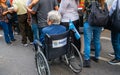 Disabled person in a chair at the festival of the Bolivian community