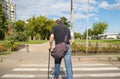 Disabled person on crutches crosses the carriageway at a crosswalk