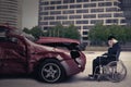 Disabled person and damaged car