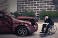 Disabled person with damaged car looks sad Royalty Free Stock Photo