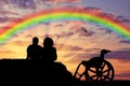 Disabled person with a nurse, happy rainbow