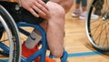 A disabled person in a wheelchair at a basketball competition in the hall. Paralympians in wheelchairs in the basketball