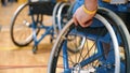 A disabled person in a wheelchair at a basketball competition in the hall. Paralympians in wheelchairs in the basketball