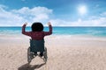 Disabled person in a wheelchair at beach Royalty Free Stock Photo